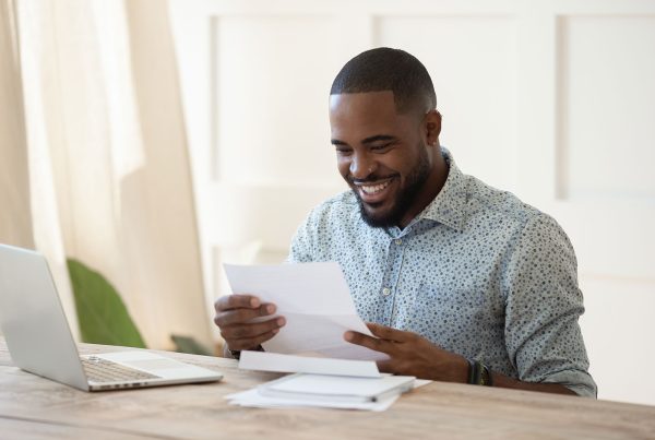 Man looks excitedly at document in front of him