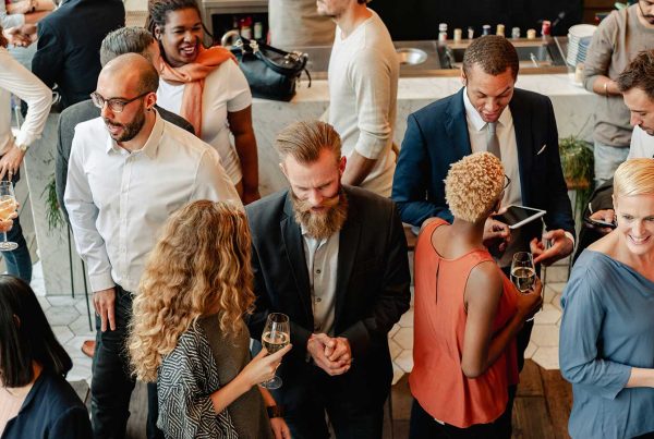 Group of professionals of all ages and backgrounds mingling at a networking event